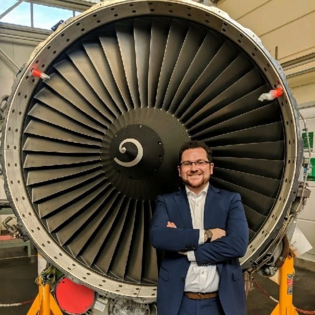 Colin Geraghty standing in front of a jet engine