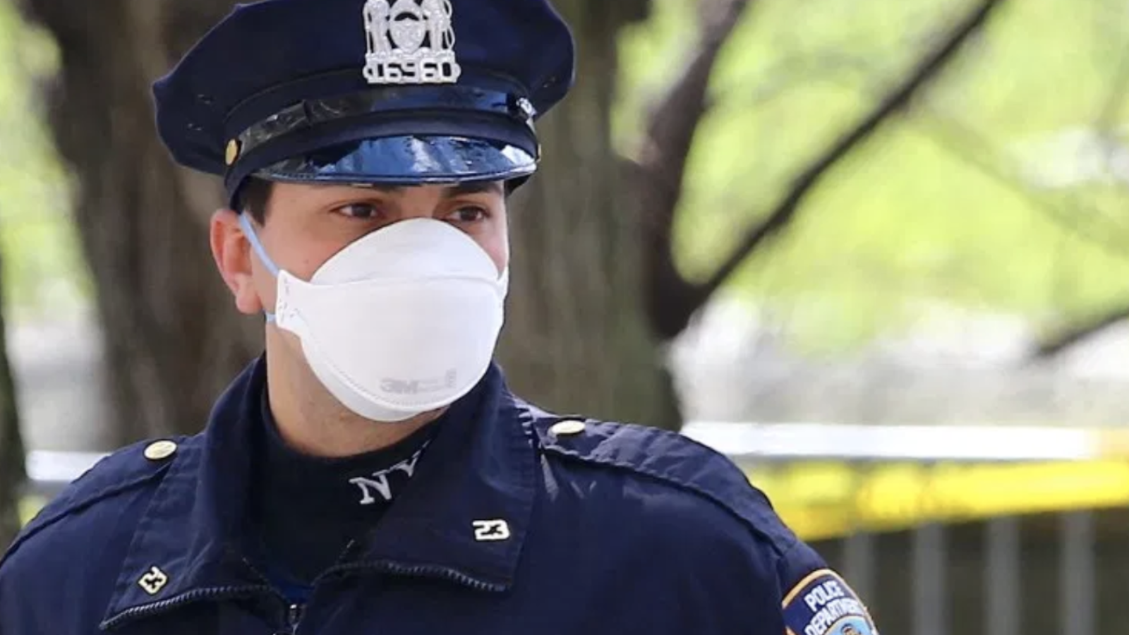 A police officer wears an N95 mask