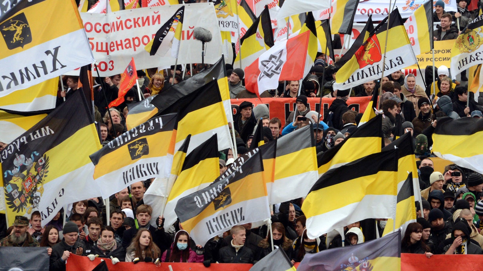 Russian ultra-nationalists wave Russian Empire&#039;s black-yellow-white flags as they take part in the so-called &quot;Russian March&quot; in central Moscow