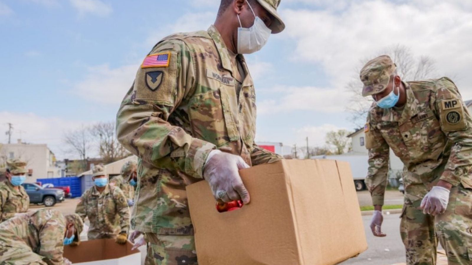 Military troops in protective masks transport supplies