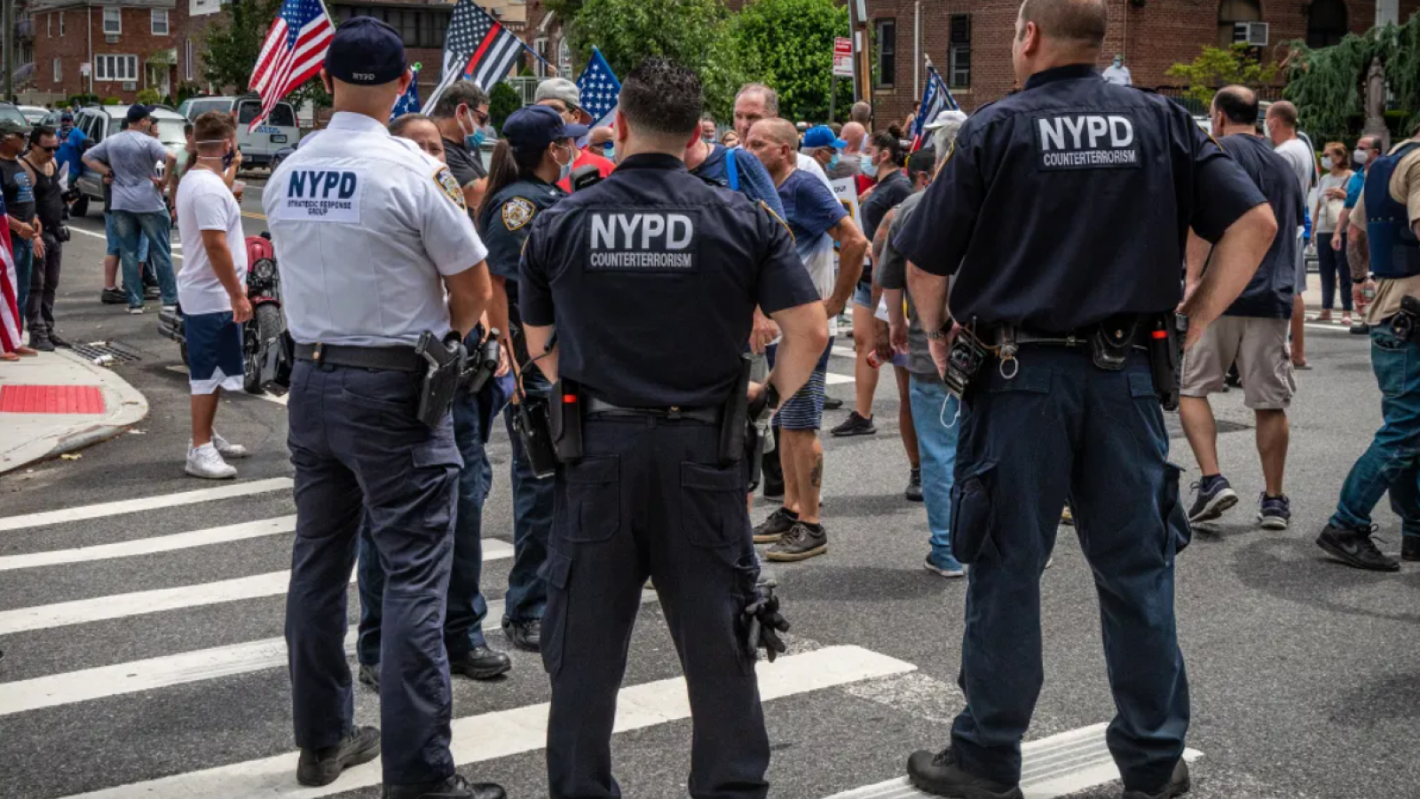 NYPD counterterrorism officers stand in front of a crowd