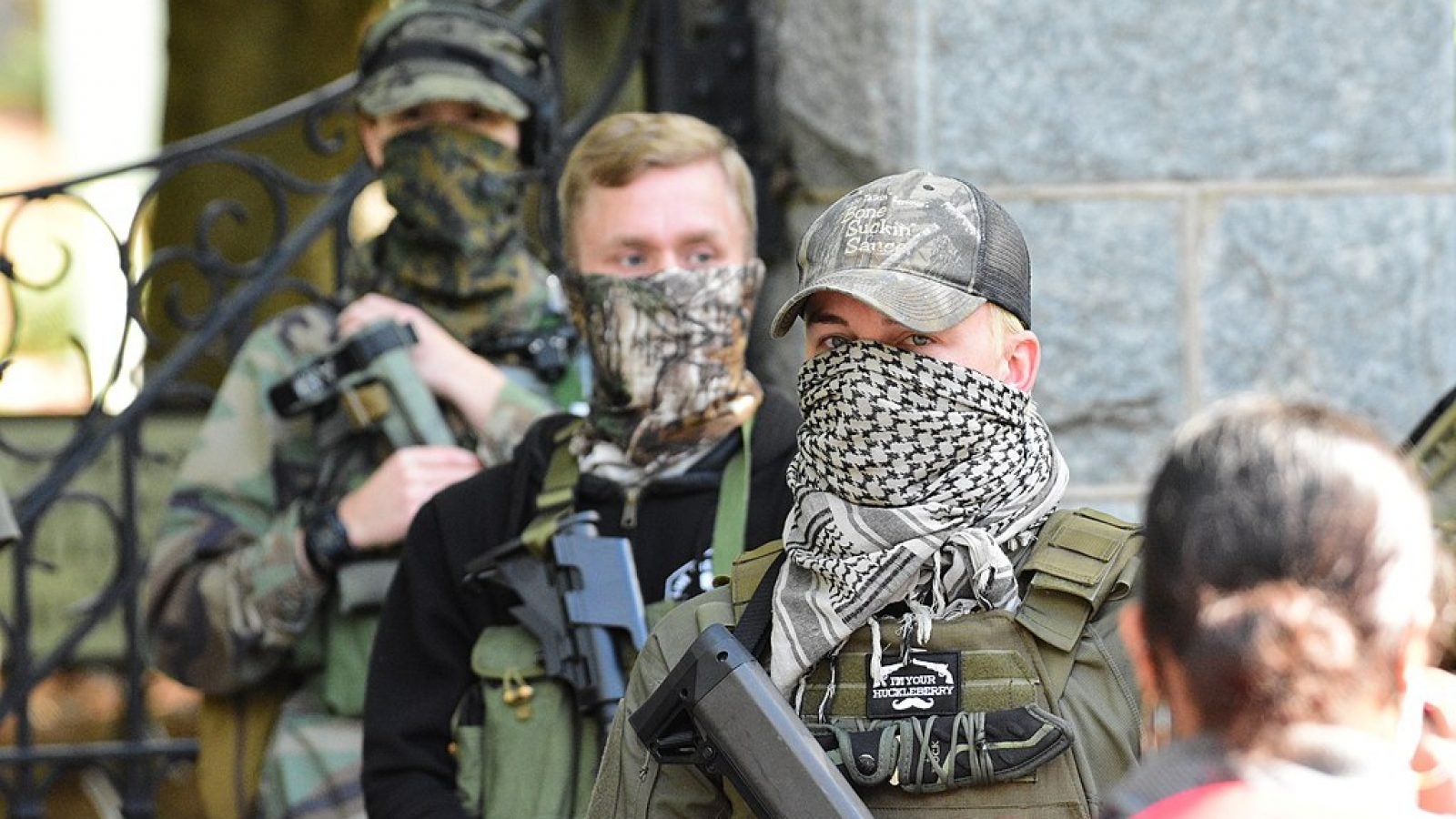 Masked Boogaloo bois attend a rally carrying rifles.