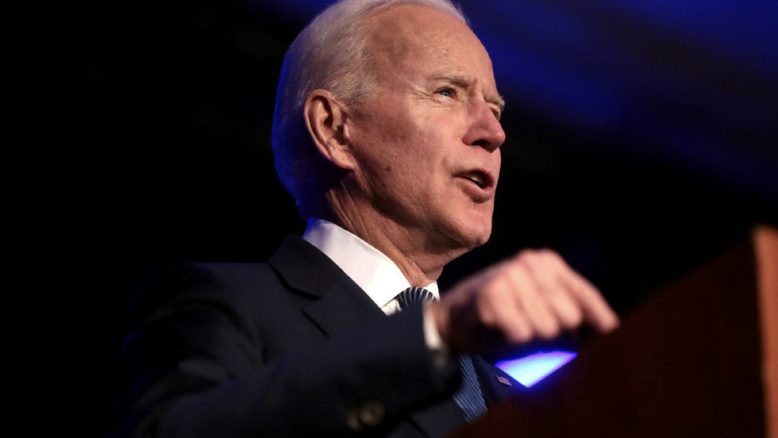 A photograph of Biden speaking behind a podium.