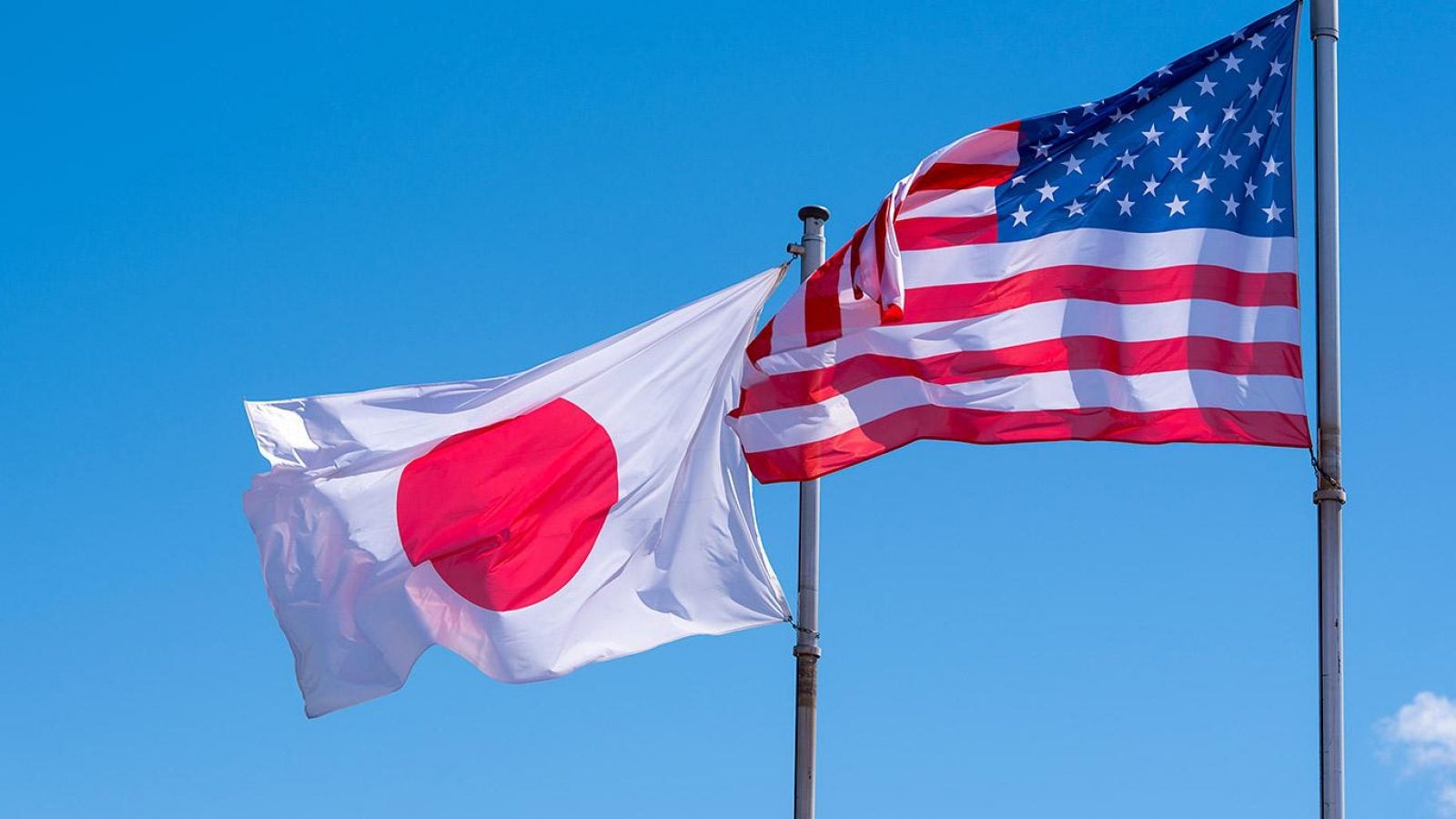 The U.S. and Japanese flags fly side by side.