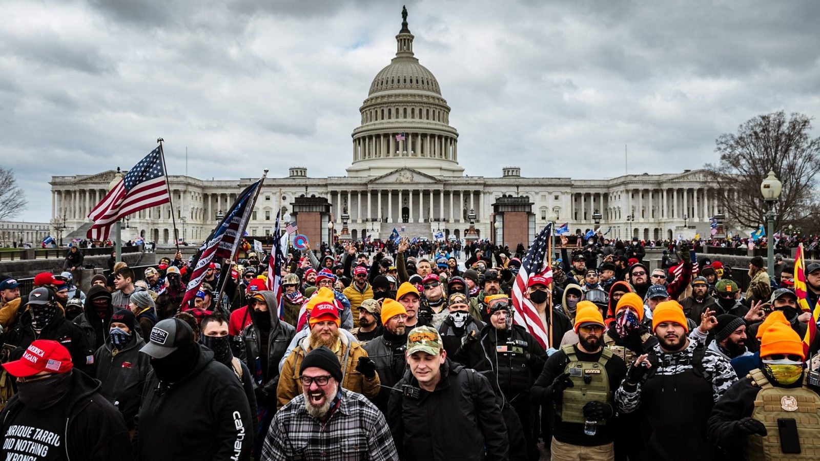 A mass of Trump supporters gather in front of the U.S. Capitol with flags