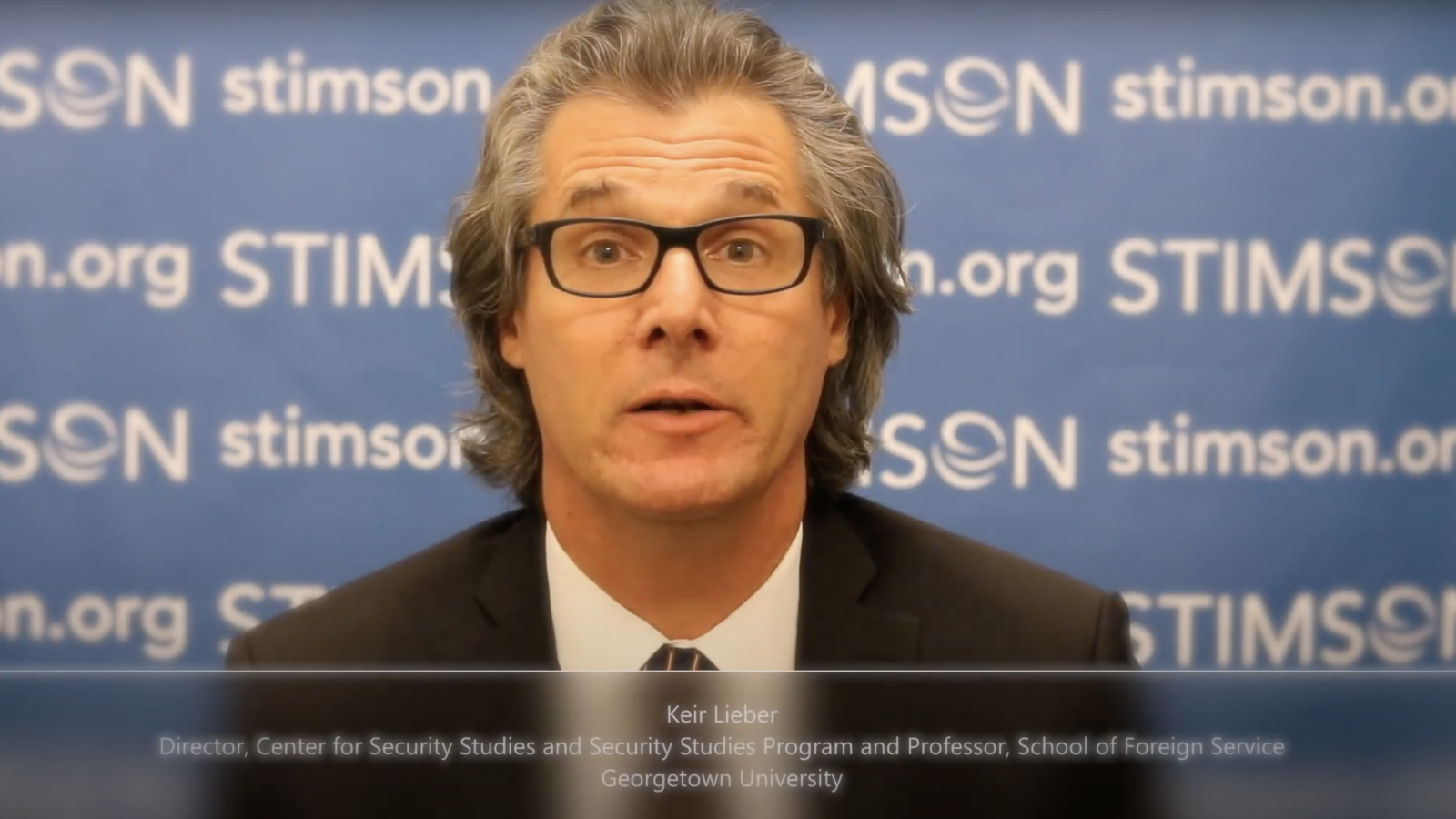 Keir Lieber is in front of a board that says Stimson with text at the bottom that says Keir Leiber, Director, Center for Security Studies and Security Studies Program, and Professor, School of Foreign Service, Georgetown University