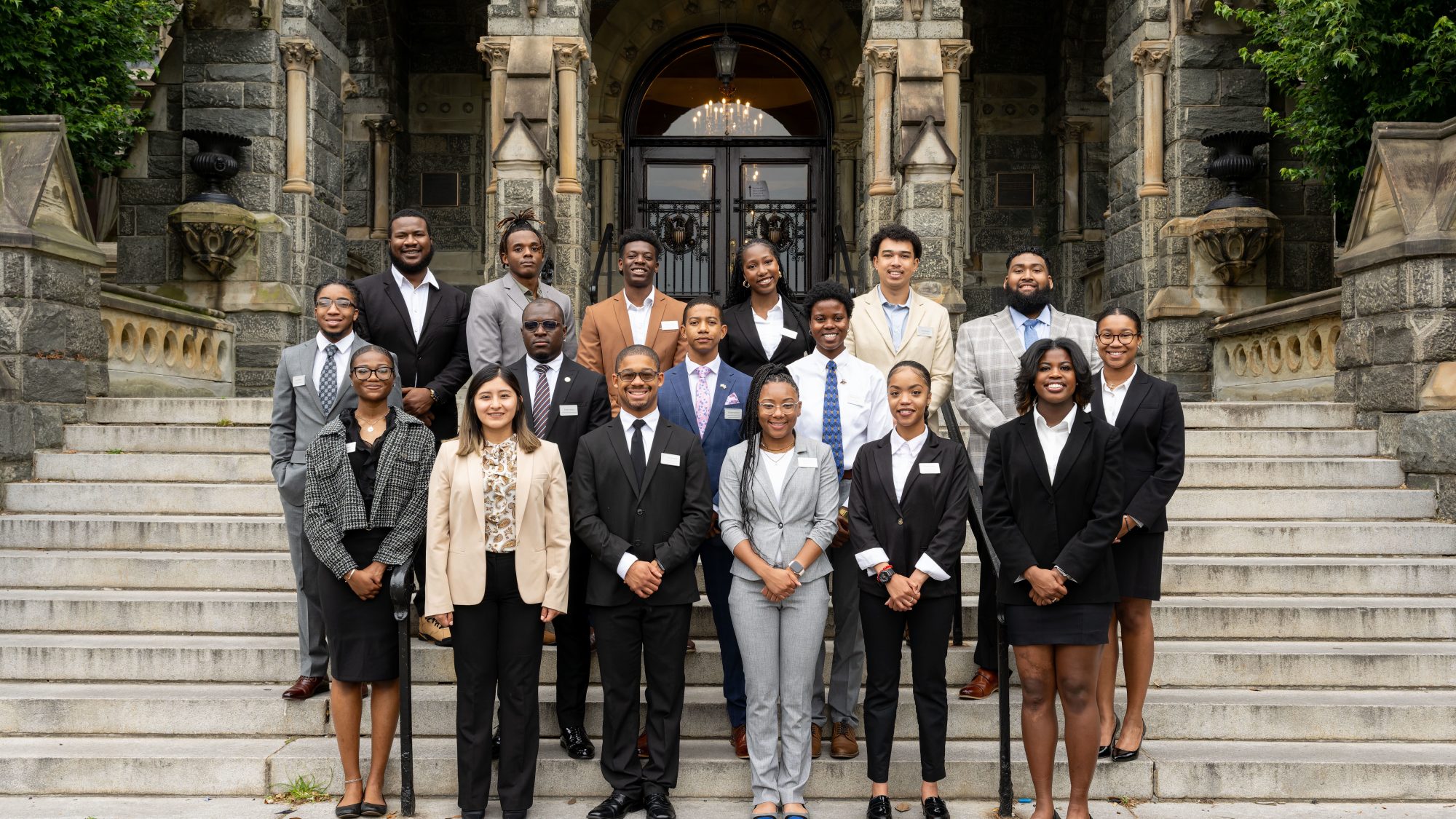 The Security Studies Summer Institute cohort for 2023 stands on the steps of Healy Hall, the historic Georgetown building.