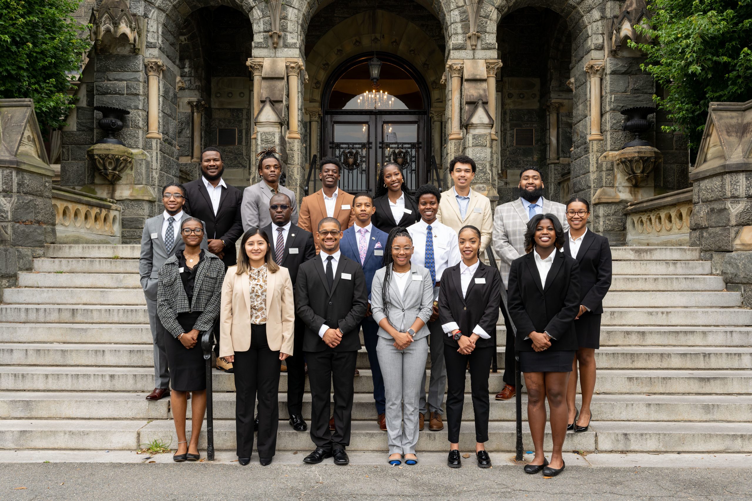 The Security Studies Summer Institute cohort for 2023 stands on the steps of Healy Hall, the historic Georgetown building.